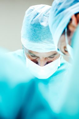 Male surgeons working in operating room at hospital